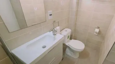 a bathroom with a toilet and a sink and a mirror at STAY Nissi Heaven Studio in Ayia Napa