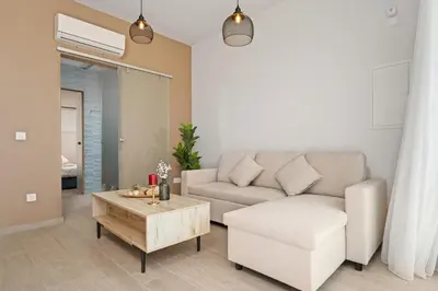 a living room with a couch and a coffee table at SunnyVillas Suite Mythical GYM Swimming Pool S21 in Paralimni