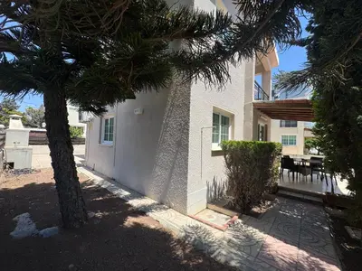 a house with a palm tree in front of it at Sea side House in Voroklini
