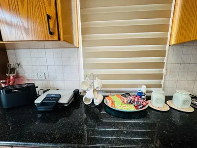 a kitchen with a counter top with dishes on it at Sea side House in Voroklini