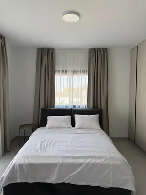 a bedroom with a large white bed with a window at ΘΕΑ 5 Comfortable 1BR and 2BR Apartments in Mor Menekshe