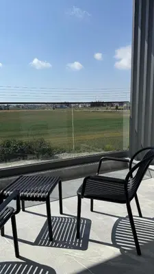 two benches on a porch with a view of a field at ΘΕΑ 5 Comfortable 1BR and 2BR Apartments in Mor Menekshe