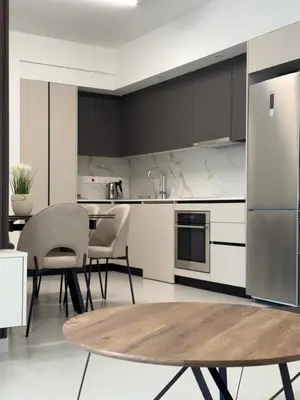 a kitchen with a table and chairs and a refrigerator at ΘΕΑ 5 Comfortable 1BR and 2BR Apartments in Mor Menekshe
