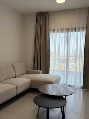 a living room with a couch and a table at ΘΕΑ 5 Comfortable 1BR and 2BR Apartments in Mor Menekshe