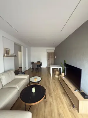 a living room with a couch and a table at Stylish 2 bedroom apartment in Limassol in Limassol