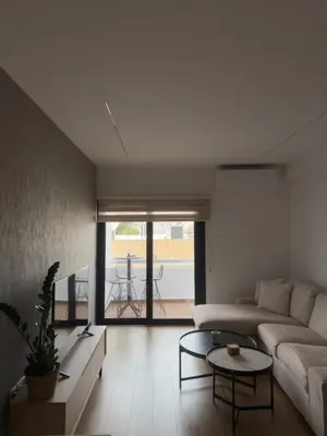 a living room with a couch and a table at Stylish 2 bedroom apartment in Limassol in Limassol