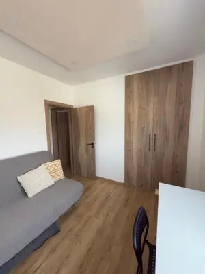 a bedroom with a bed and a wooden floor at Stylish 2 bedroom apartment in Limassol in Limassol