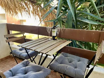 a picnic table with a bottle of wine and two chairs at STAY Napa Dreams Apartment in Ayia Napa