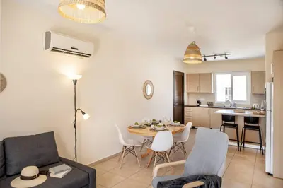 a living room with a couch and a table at SunnyVillas 2BR Mythical Apt Swimming Pool BF03 in Paralimni