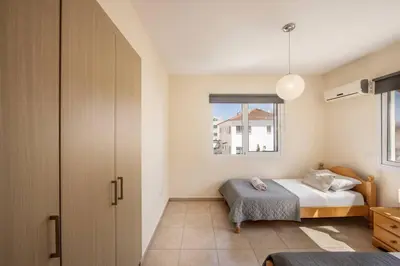 a bedroom with a bed and a window at SunnyVillas 2BR Mythical Apt Swimming Pool BF03 in Paralimni