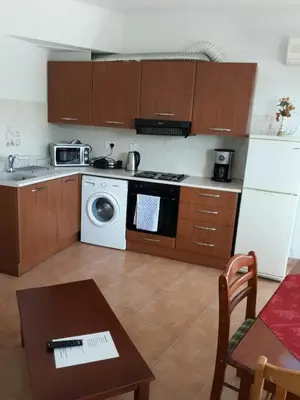 a kitchen with a stove and a washing machine at Yialos Apartments in Pissouri