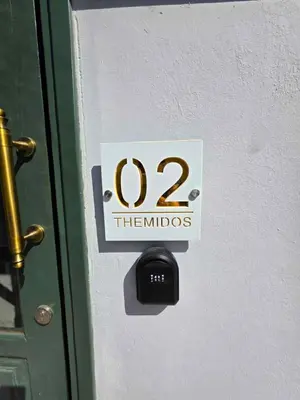 a sign on a door with the number of the holidays at Mavrommati Luxury Residence no1 in Limassol