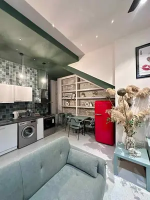 a living room with a blue couch and a red refrigerator at Mavrommati Luxury Residence no1 in Limassol