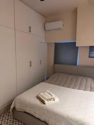 a small room with a bed with towels on it at Mavrommati Luxury Residence no1 in Limassol