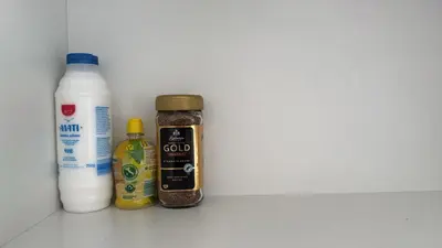 a shelf with spices and a bottle of milk at Sun Shine Studio With Balcony in Larnaka