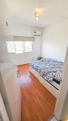 a bedroom with a bed and a wooden floor at Central Rooms, 500m to Larnaca Marina in Larnaka