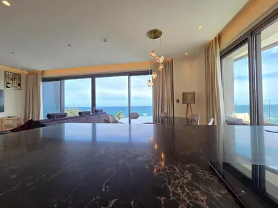 a living room with a large dining table with a view of the ocean at Luxury Seaview Escape 3bd in Limassol Skyscraper in Limassol