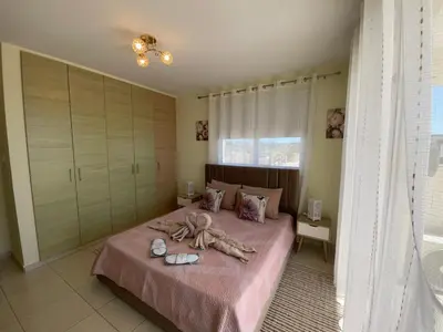 a bedroom with a bed with a bunch of towels on it at Nissi Beach sunny cozy apartment in Ayia Napa