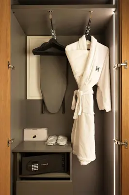 a room with a closet with towels and a microwave at Pendeli Resort in Platres