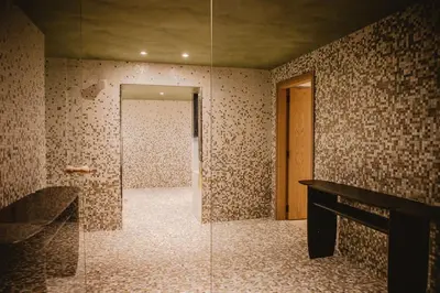 a bathroom with a shower and a glass door at Pendeli Resort in Platres