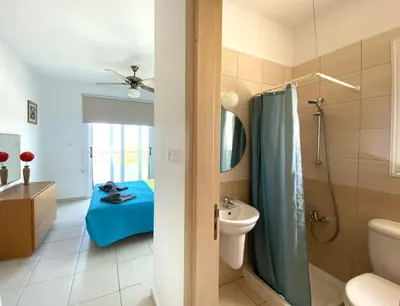 a bathroom with a bed and a toilet and a sink at Athena Holiday Villa DPS01 in Protaras