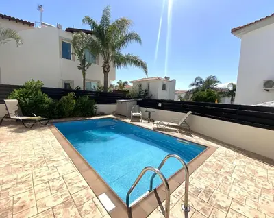 a swimming pool on the side of a house at Athena Holiday Villa DPS01 in Protaras