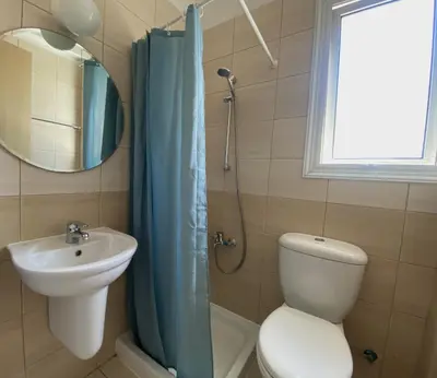 a bathroom with a toilet and a sink and a mirror at Athena Holiday Villa DPS01 in Protaras