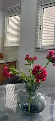 a vase filled with pink flowers on a table at The Catherine in Larnaka