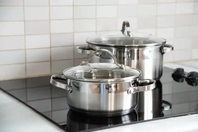 two pots on a stove in a kitchen at Pavilion Apt Cozy 2BR by Elysio in Paralimni