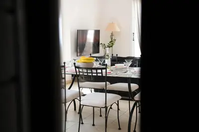 a dining room with a table and chairs with bananas on it at Pavilion Apt Cozy 2BR by Elysio in Paralimni