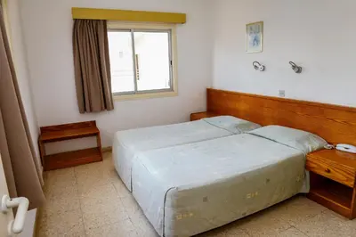 a bedroom with a large bed and a window at Sweet Memories STANDARD Apts in Protaras