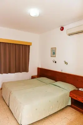 a bedroom with a large bed and a window at Sweet Memories STANDARD Apts in Protaras