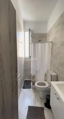 a white bathroom with a toilet and a shower at 1 bedroom apartment in egkomi makedontissa near unic in Strovolos