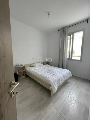 a white bedroom with a bed and a window at 1 bedroom apartment in egkomi makedontissa near unic in Strovolos