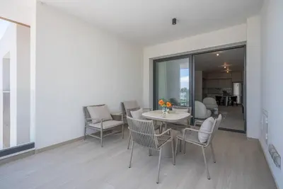 a dining room with a table and chairs at Kalamon Luxury Suite 202 w Pool and Gym in Larnaka