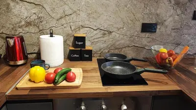 a cutting board with fruits and vegetables on a counter at Boutique & Brand New Prime Location Park & Beach in Limassol