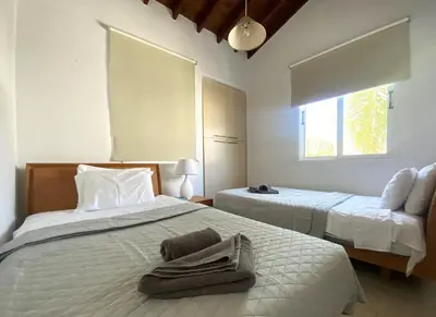 a bedroom with two beds and a towel on the bed at Artemis Holiday Villa DPS09 with pool in Paralimni