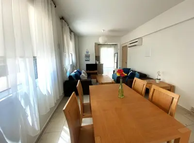 a living room with a table and a couch at Artemis Holiday Villa DPS09 with pool in Paralimni