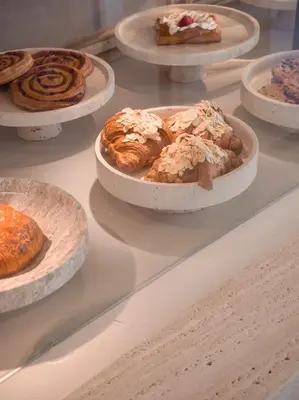 a display case filled with different types of pastries at kolektif suites in Kérynia
