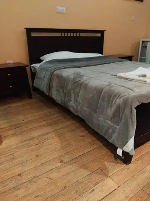a bedroom with a bed and a wooden floor at PAOK Kakopetria in Aglantzia