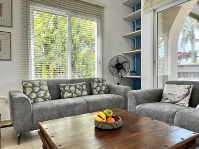 a living room with a couch and a table with a bowl of fruit at STAY Thalassa Villa in Paralimni