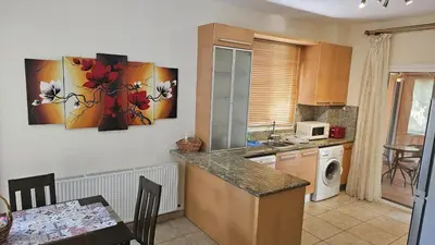 a kitchen with a table and a counter top at STAY Nissi House in Ayia Napa
