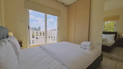 a bedroom with a bed with two towels on it at STAY Nissi House in Ayia Napa