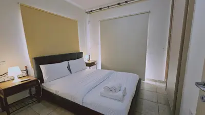 a bedroom with a bed with two towels on it at STAY Nissi House in Ayia Napa