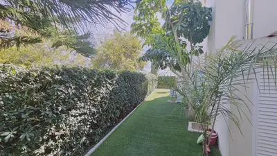 a garden with green grass next to a building at STAY Nissi House in Ayia Napa
