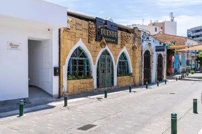a street with a building with arched windows on it at Le Bandit Studio in Larnaka