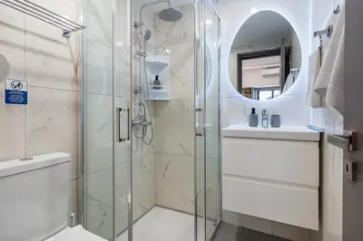 a bathroom with a shower and a toilet and a sink at Le Bandit Studio in Larnaka