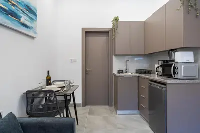 a kitchen with a table and a dining room at Le Bandit Studio in Larnaka