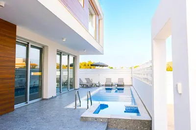 a swimming pool in the backyard of a house at Nissinest Luxury Villas in Ayia Napa