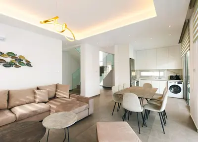 a living room with a couch and a table at Nissinest Luxury Villas in Ayia Napa